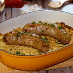 Deux diots savoyards grillés sur un lit de crozets gratinés, parsemés de persil frais. Un plat réconfortant prêt à être dégusté.